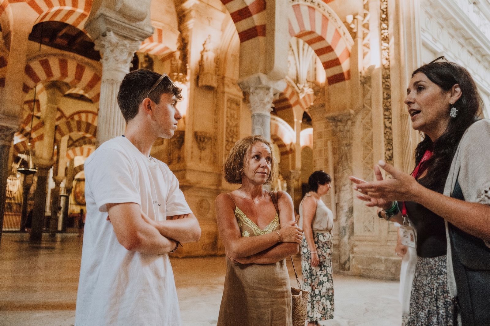 A licensed guide explains the Mezquita of Córdoba to a mother and her son during a private visit.