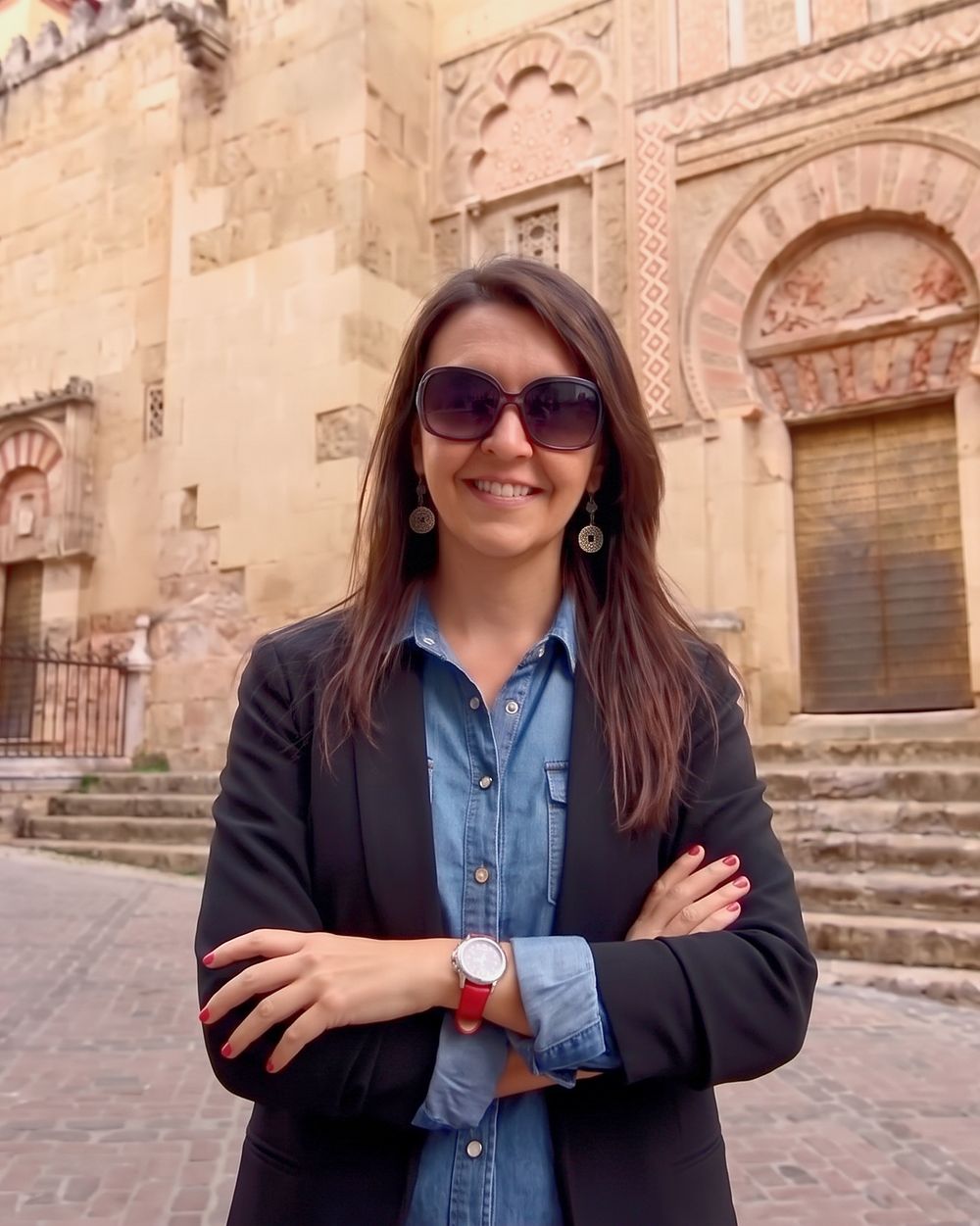 Your guide, smiling in front of the façade of the Mezquita of Córdoba.