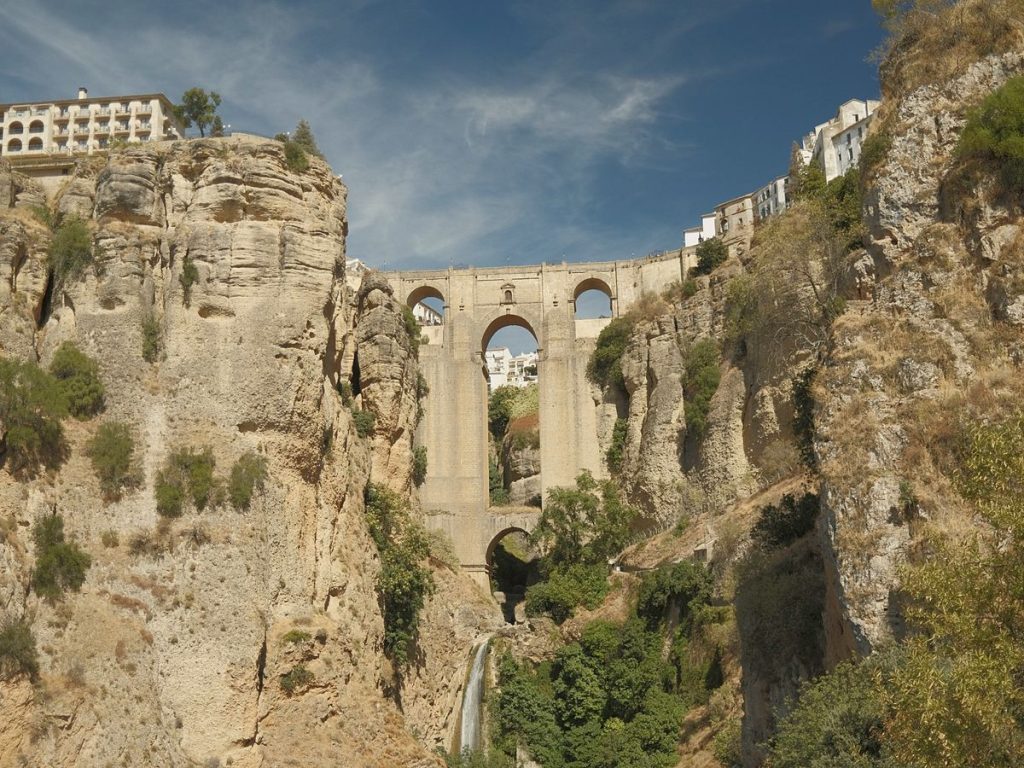 The Puente Nuevo of Ronda spanning the gorge, with whitewashed houses on the cliff edge.