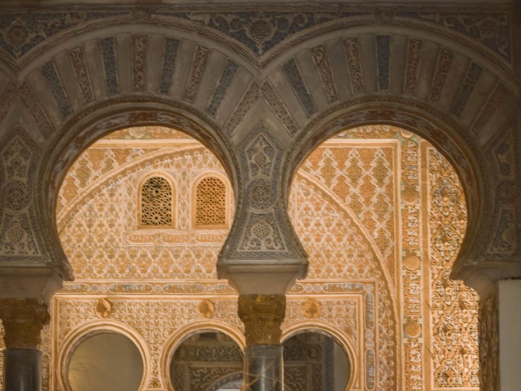 Horseshoe arches and plasterwork at the Royal Alcázar of Seville.